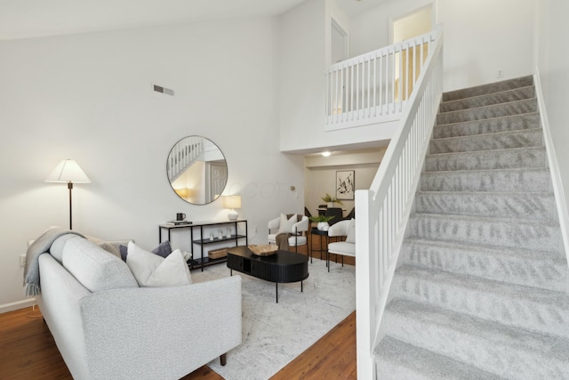 living room featuring a high ceiling and hardwood / wood-style floors