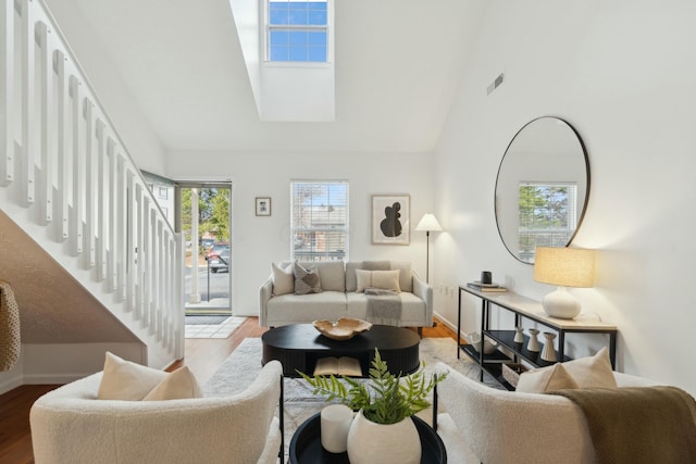 living room with lofted ceiling and hardwood / wood-style flooring