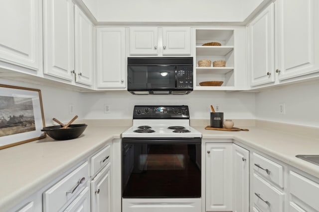 kitchen featuring electric range and white cabinets