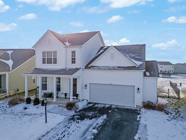 view of front of home with covered porch and a garage