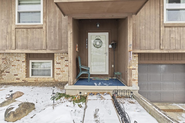 view of exterior entry featuring a garage