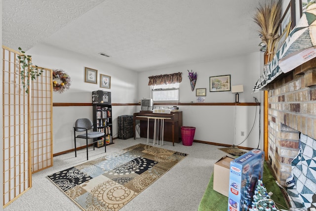 living area with carpet flooring and a textured ceiling