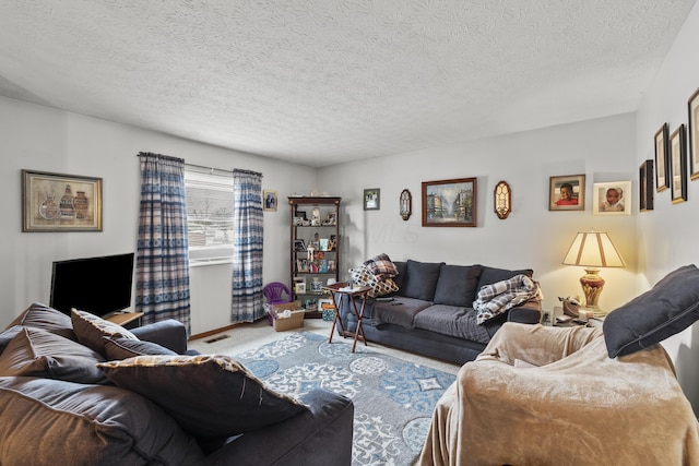 living room featuring carpet floors and a textured ceiling