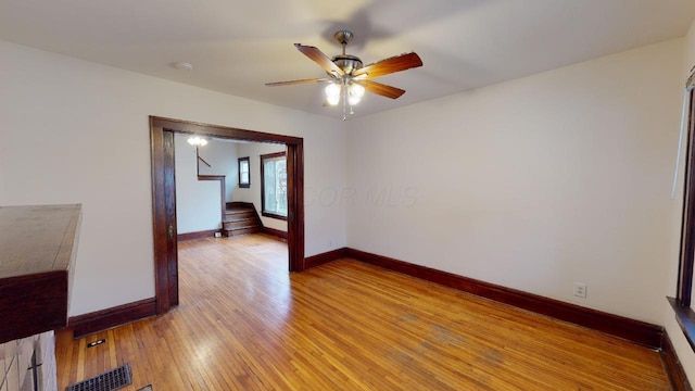 empty room with ceiling fan and light wood-type flooring