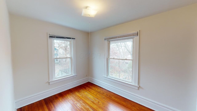 spare room with hardwood / wood-style floors