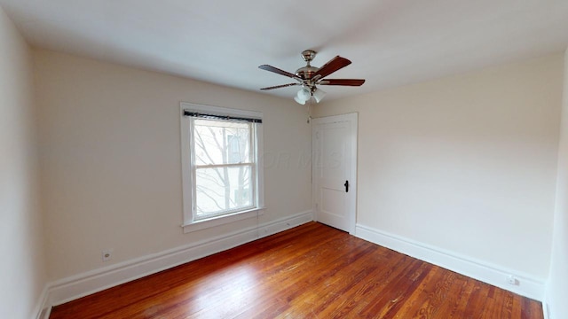 spare room with hardwood / wood-style floors and ceiling fan