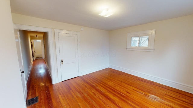 spare room with hardwood / wood-style floors