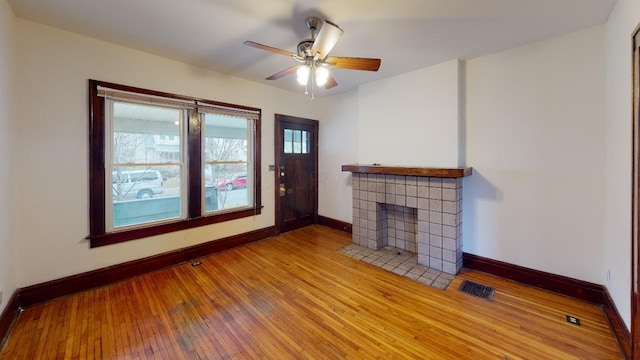 living room featuring ceiling fan and hardwood / wood-style floors