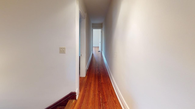 corridor with dark hardwood / wood-style flooring