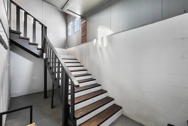 stairs featuring concrete floors