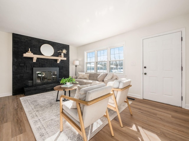 living room featuring hardwood / wood-style floors and a fireplace