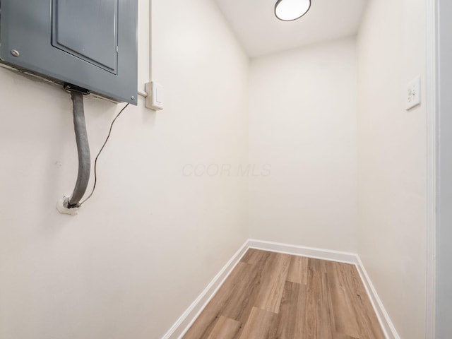 interior space featuring electric panel and hardwood / wood-style floors