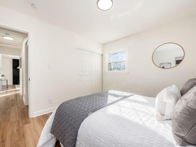 bedroom with a closet and light wood-type flooring