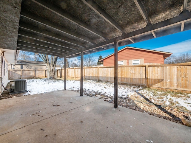 snow covered patio featuring cooling unit