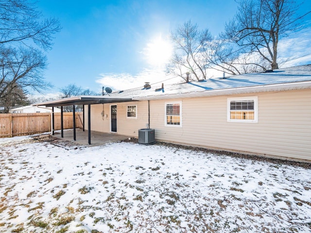 snow covered property featuring cooling unit and a patio