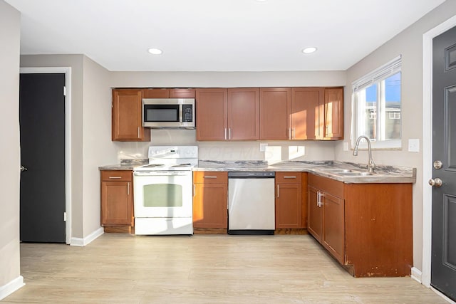 kitchen with sink, light hardwood / wood-style flooring, and stainless steel appliances