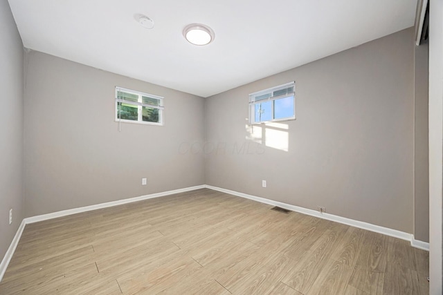 unfurnished room with light hardwood / wood-style flooring