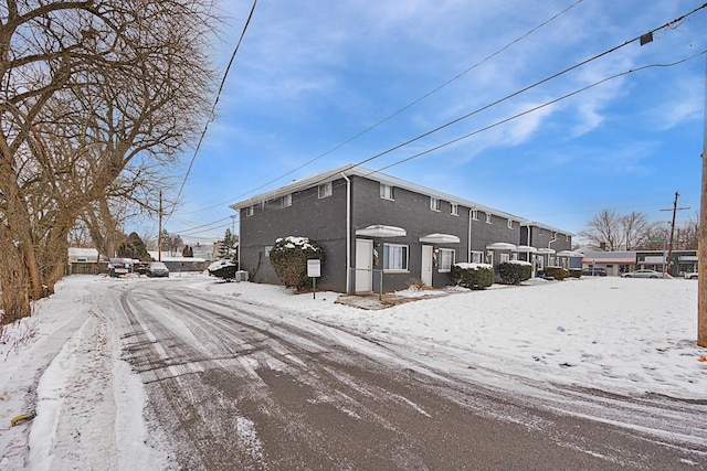 view of snow covered back of property