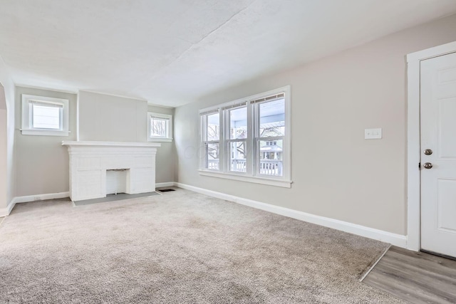 unfurnished living room featuring carpet flooring