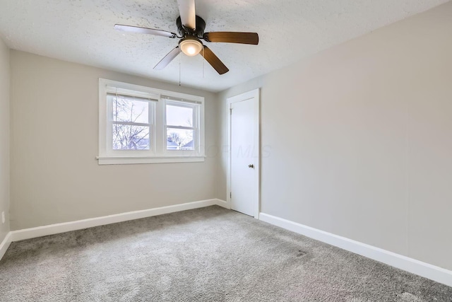 unfurnished room with ceiling fan, carpet floors, and a textured ceiling