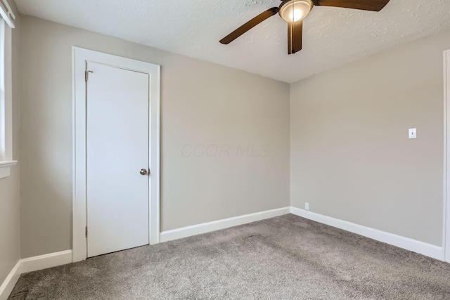 unfurnished room with carpet, a textured ceiling, and ceiling fan