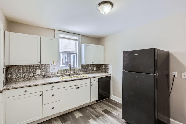 kitchen featuring white cabinetry, sink, decorative backsplash, and black appliances