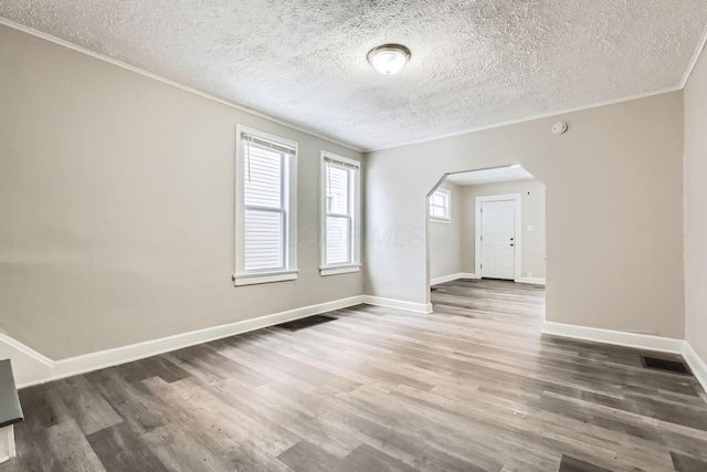 spare room with dark hardwood / wood-style flooring and a textured ceiling