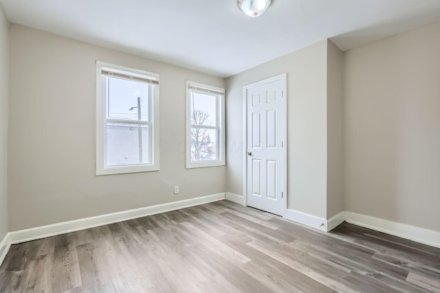 unfurnished bedroom with hardwood / wood-style flooring and a closet