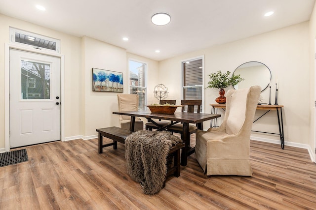 dining space with wood-type flooring and plenty of natural light