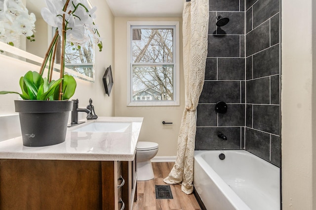 full bathroom with wood-type flooring, toilet, vanity, and shower / bathtub combination with curtain