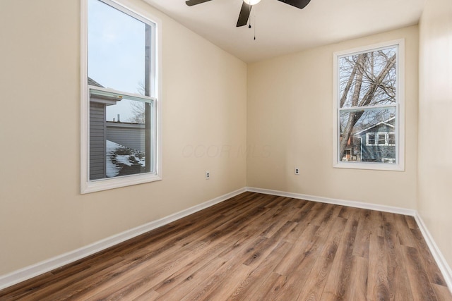 empty room featuring ceiling fan and hardwood / wood-style floors