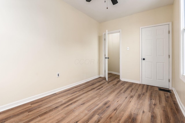 unfurnished bedroom with ceiling fan and light hardwood / wood-style floors