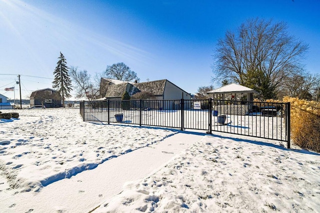 snow covered gate featuring a gazebo