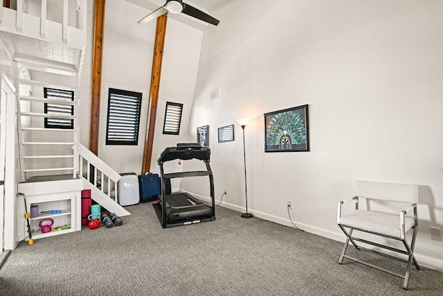 exercise room featuring a high ceiling, carpet, and ceiling fan