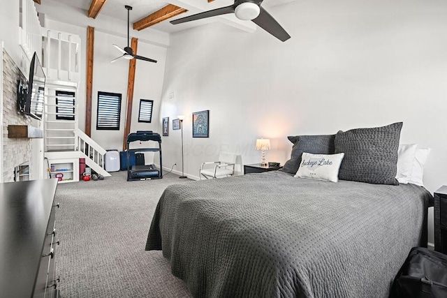 carpeted bedroom with beamed ceiling and ceiling fan