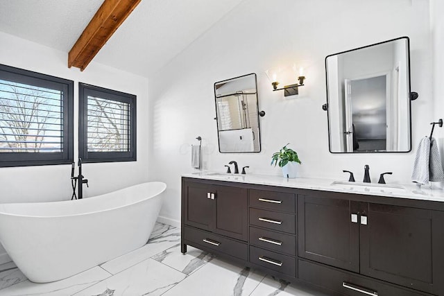 bathroom with vanity, a tub to relax in, and vaulted ceiling with beams