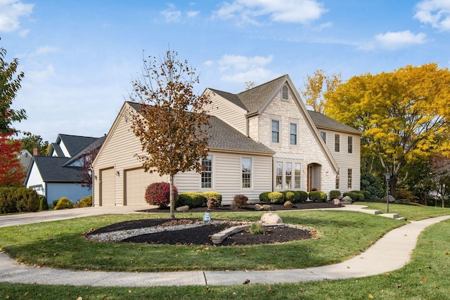 view of front of house featuring a garage, stone siding, driveway, roof with shingles, and a front yard