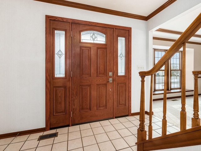 foyer entrance featuring visible vents, crown molding, stairway, and light tile patterned floors