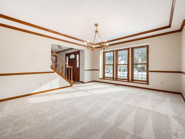 interior space with light carpet, baseboards, a raised ceiling, ornamental molding, and stairs