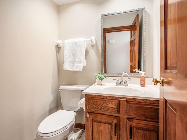 half bathroom with toilet and vanity