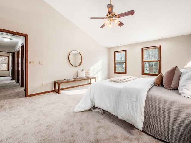 bedroom featuring vaulted ceiling, baseboards, a ceiling fan, and light colored carpet