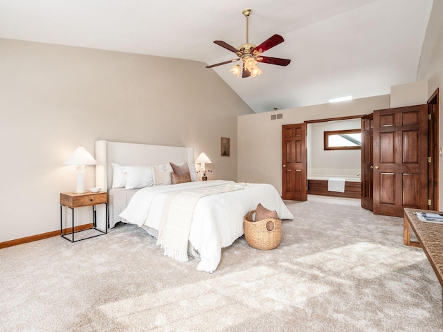 bedroom with visible vents, light carpet, ensuite bath, high vaulted ceiling, and baseboards