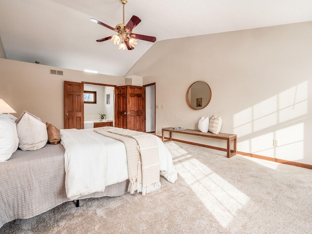 bedroom featuring lofted ceiling, ceiling fan, carpet flooring, visible vents, and ensuite bath