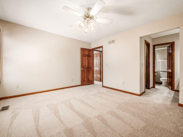 unfurnished room featuring light colored carpet, visible vents, and baseboards