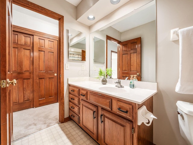 bathroom with vanity, toilet, and tile patterned floors