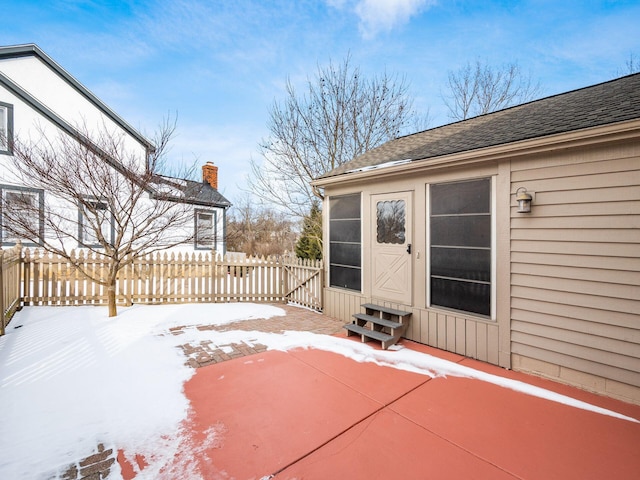 snow covered patio with entry steps and fence