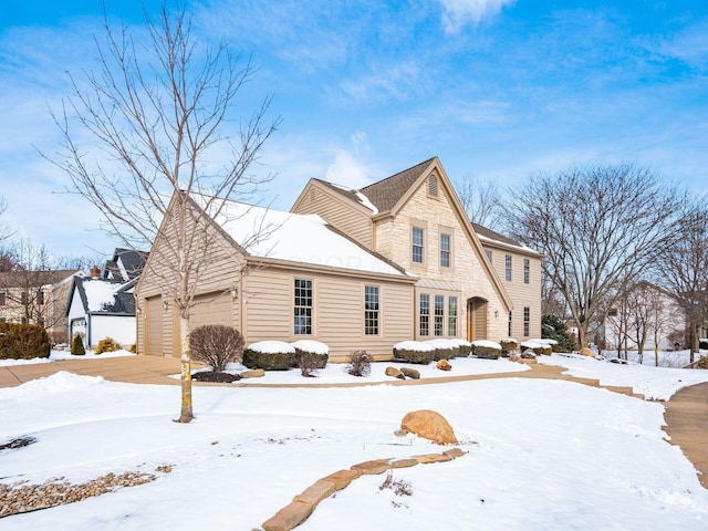 view of front of house featuring a garage and stone siding