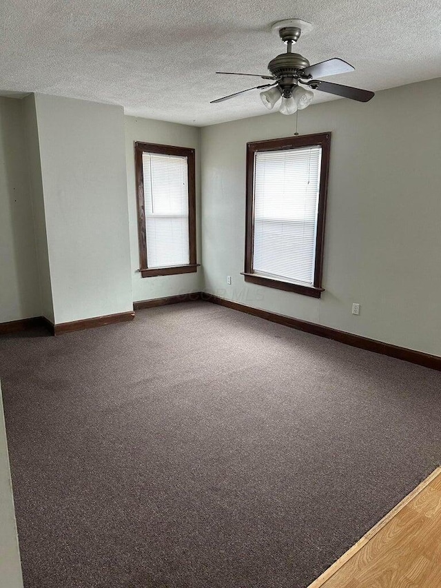 unfurnished room with ceiling fan, hardwood / wood-style floors, and a textured ceiling