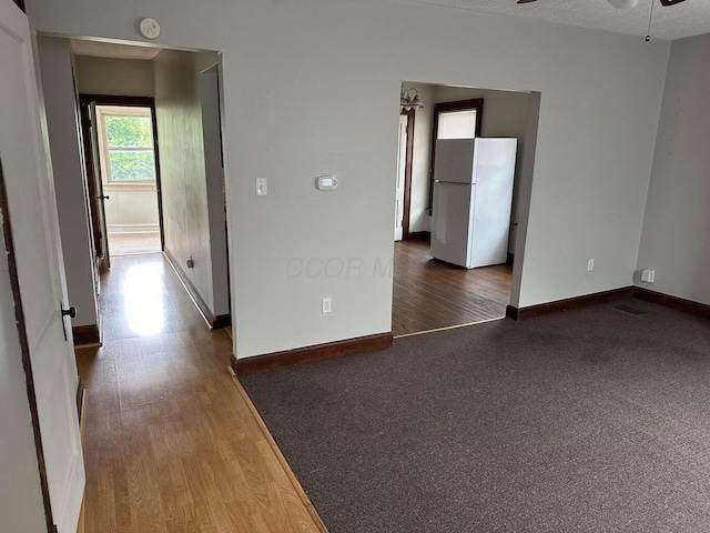 spare room with ceiling fan and dark hardwood / wood-style flooring