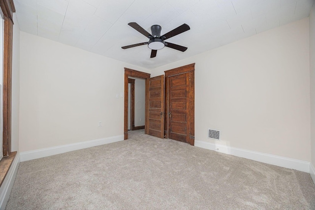 unfurnished bedroom with ceiling fan and carpet flooring